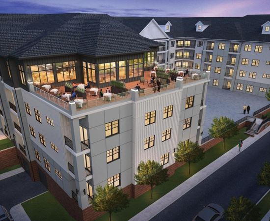 A large, modern building with a lot of windows and a spacious courtyard.